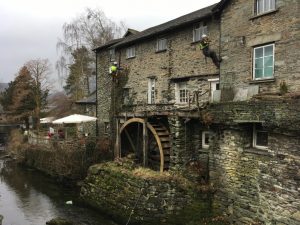 Rope access technicians carrying out vegetation removal at The Giggling Goose cafe, Ambleside